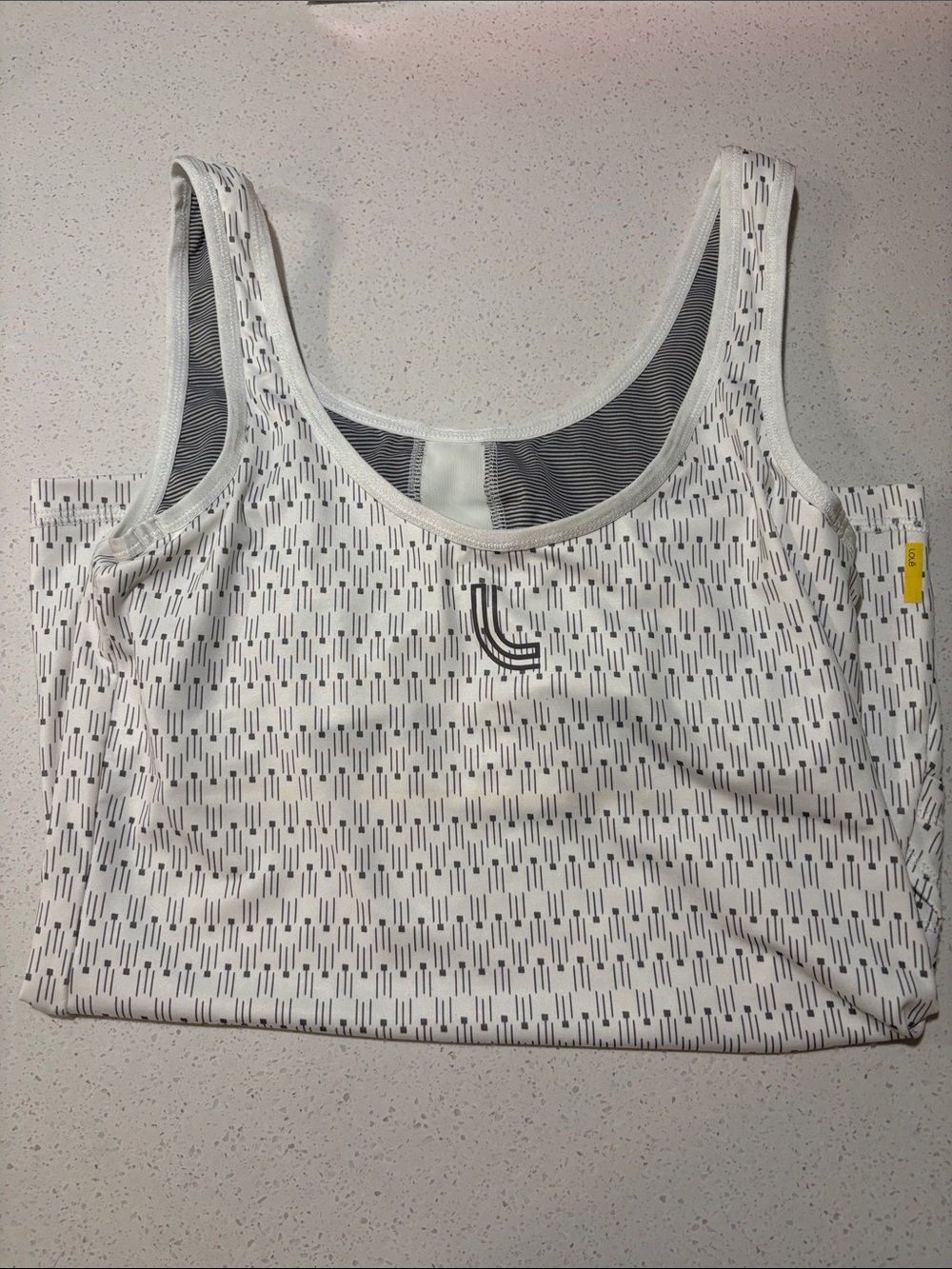 Cropped White Patterned Sports Bra with Subtle Black Logo